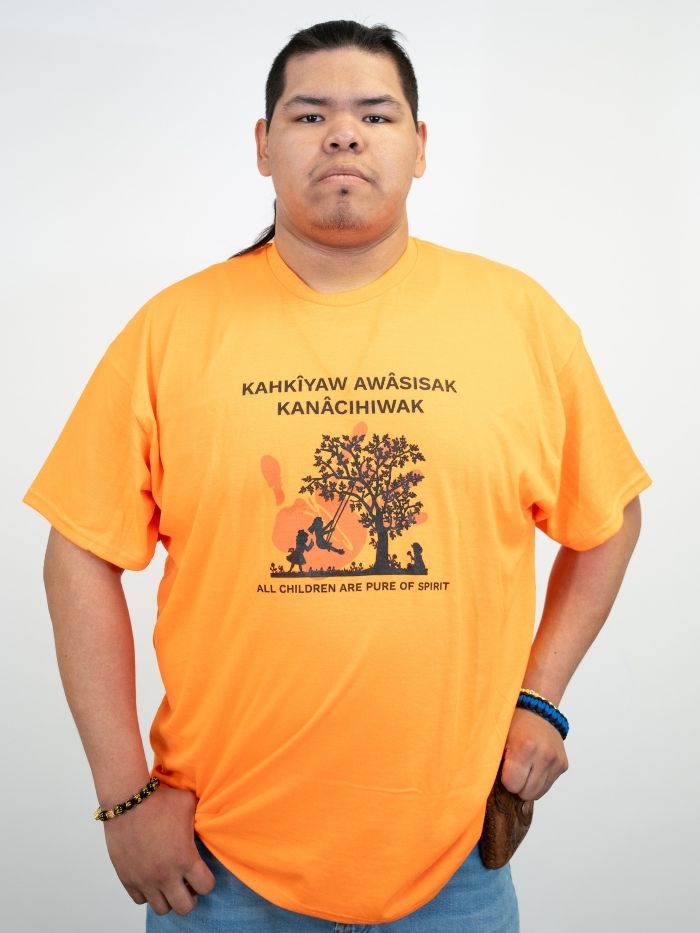 Tyrece wearing Kanâcihiwak t-shirt
